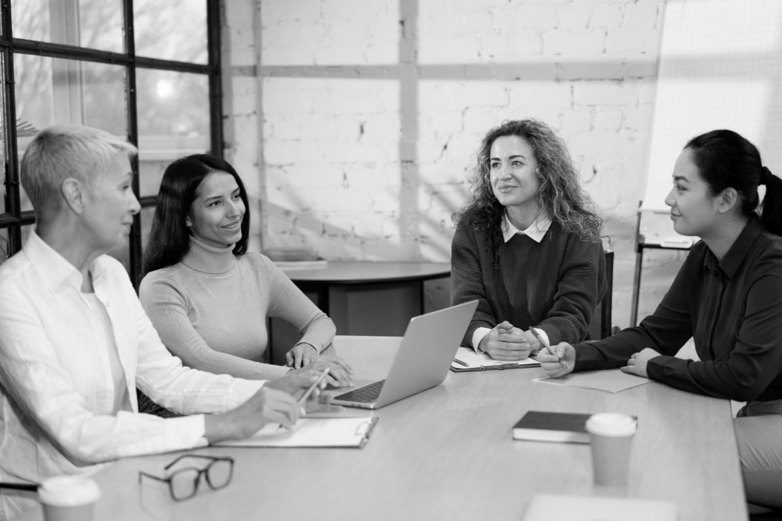 Professional meeting space where partnership discussions take place with testing frameworks displayed
